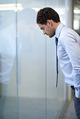 Image showing Man, business and leaning on glass wall with stress for financial deal failure or company, mistake or frustrated. Male person, unhappy and career error in New York building, burnout or overwhelmed