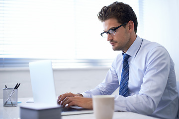 Image showing Businessman, laptop and typing in office or communication as financial consultant, email or internet. Male person, glasses and corporate company in New York or accounting research, loan or investment