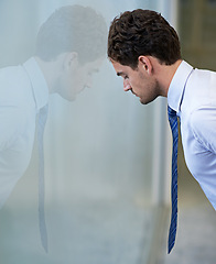 Image showing Man, business and leaning on glass wall or tired for financial deal for company overtime, mistake or frustrated. Male person, unhappy and career error in New York building, burnout or overwhelmed