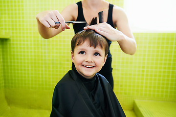 Image showing Child, boy and mother with haircut in home for grooming, hairstyle and happiness with scissors. Barber, person and kid for hair treatment, haircare and hairdressing with comb and smile in bathroom