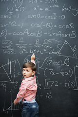 Image showing Smart, math and child writing on chalkboard in school or classroom for learning, education or solution. Genius and clever kid, boy or student with equation, numbers and test for IQ or intelligence