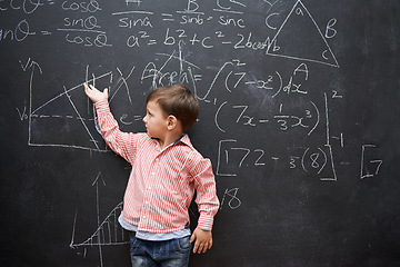 Image showing Child, boy and blackboard with math or equations for knowledge, numbers and hand gesture in classroom at school. Kid, student and learning by chalkboard for problem solving, studying and preschool