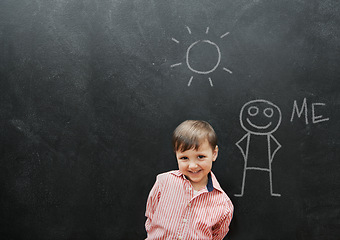 Image showing Child, boy and portrait or smile by blackboard with drawing, character or creative fun in classroom at school. Kid, student or happy for illustration, education or chalkboard with mockup at preschool