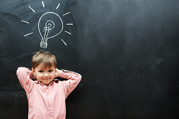 Image showing Student, child and chalkboard with lightbulb for solution, learning and creative ideas in school on mockup space. Portrait of a kid, learner or boy with light bulb, emoji and blackboard for knowledge