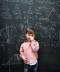 Image showing Child, boy and portrait with smile by blackboard with equations, numbers and education in classroom at school. Kid, student and happy for knowledge, learning and chalkboard with math and preschool