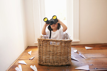 Image showing Binoculars, paper plane and child playing with adventure, imagination and fun in basket at home. Fantasy, little pilot and playful boy in box with future dream, growth and development with airplane