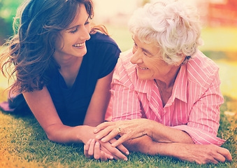 Image showing Smile, senior mother and woman holding hands on grass outdoor to relax, support and bonding together. Park, elderly person and adult daughter in garden for connection, relationship and love of family