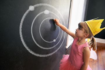 Image showing Child, board and drawing solar system for education with chalk in classroom with costume for creative, learning and guidance. Kid, chalkboard and crown for picture student in school for knowledge