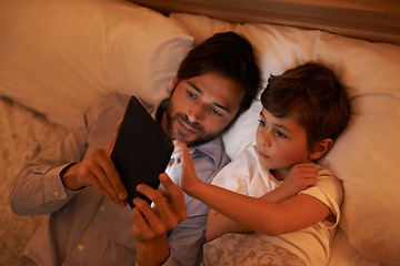 Image showing Bedroom, father and son with tablet, evening and family with ebook and connection with social media. Dad, home and boy with tech or bedtime with lights or bonding together with hobby or storytelling