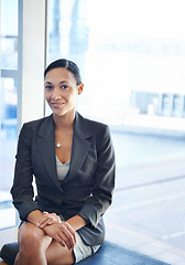 Image showing African woman, portrait and sitting in lobby for business interview, career and office job. Female recruit, smiling and professional for corporate, industrial work and future employee for company