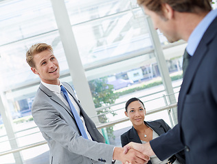 Image showing Handshake, deal and business men in office for agreement, partnership or collaboration. Smile, meeting and professional people shaking hands with manager for onboarding or hiring welcome in workplace