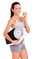 Image showing Scale, apple and portrait of woman in studio with snack for weight loss, health and wellness diet. Fitness, vitamins and female person eating organic, fresh and nutrition fruit by white background.