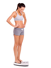 Image showing Finally. Scale, happy and woman in studio for weight loss, health and wellness diet victory or success. Smile, fitness and person measuring body for exercise, workout or training by white background.