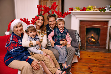 Image showing Christmas, portrait and happy big family on sofa in home for holiday or festive celebration. Xmas, parents and smile of children with grandmother in living room, antlers or bonding together at party
