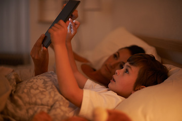 Image showing Bedroom, mother and son with tablet, night and family with ebook and connection with social media. Mama, home and boy with technology or bedtime story with lights or bonding together with digital app