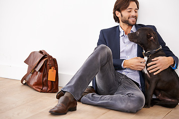 Image showing Smile, love and happy businessman with dog for bonding together with positive and good attitude. Career, briefcase and professional male person playing with pet, puppy or animal on floor at home.