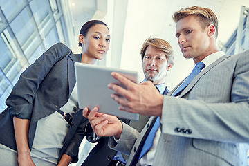 Image showing Business people, tablet and discussion for project in office, collaboration and unity for proposal. Coworkers, workplace and teamwork for reading a report, support and online for plan and networking