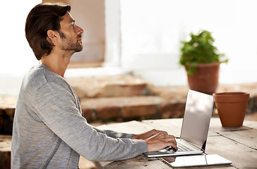 Image showing Businessman, laptop and typing or research in cafe with remote work, copywriting or freelance employee. Entrepreneur, person and technology for email, writing and online planning in coffee shop