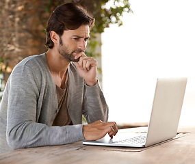 Image showing Businessman, laptop and thinking of research outdoor with remote work, relaxing or freelance writer. Entrepreneur, person and technology for reading, typing and online planning in nature at cafe