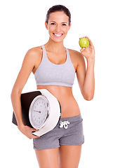 Image showing Fitness, apple and portrait of woman with scale in studio for weight loss, health and wellness diet. Vitamins, nutrition and female person eating organic fruit and measure by white background.