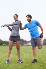 Image showing Couple, fitness and stretching body on green grass for workout, exercise or outdoor preparation. Active, young man and woman in warm up or getting ready for training or running together on open field