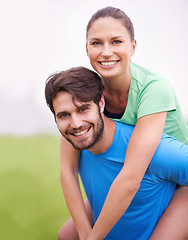 Image showing Fitness, couple and piggyback outdoor for exercise break, happy and healthy with strength and endurance. People smile for wellness, workout together in park with sports or training for bonding