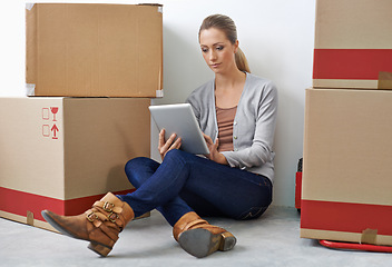 Image showing Business, boxes and woman on the floor, tablet and internet with social media and professional. Person, employee and entrepreneur with connection or digital app with network and cardboard with tech