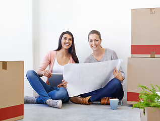 Image showing Women, blueprint and floor with planning at startup with tablet, idea or entrepreneurship with boxes. People, partnership and digital touchscreen with smile for new business with documents at company