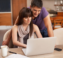 Image showing Couple, happy and laptop in kitchen with paper for budget, smile and coffee on table by pen. Partners, love and payment of apartment rent with technology, tax and online with connection from internet