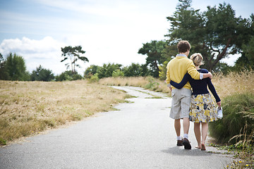 Image showing Young caucasian couple walking in a park