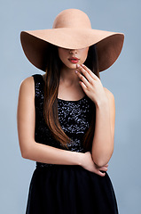 Image showing Fashion, luxury and woman in hat with vintage glamour, confidence and makeup in studio. Classic, chic and elegant style with girl on grey background for designer clothes, classy and cool aesthetic.