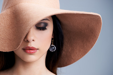 Image showing Beauty, makeup and woman in hat with glamour, confidence and vintage style in studio. Classic, chic and elegant model in cool aesthetic with girl on grey background for luxury, grace and cosmetics.