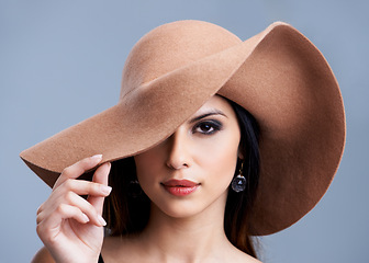 Image showing Beauty, portrait and woman in hat with glamour, confidence and vintage style makeup in studio. Classic, chic and elegant model girl in luxury aesthetic with grey background, grace and cosmetics.