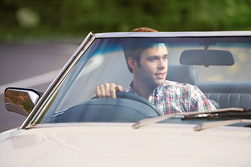 Image showing Happy man, road trip and driving car for travel, adventure or outdoor journey in nature. Young male person with smile in convertible vehicle for transportation, holiday getaway or drive on street
