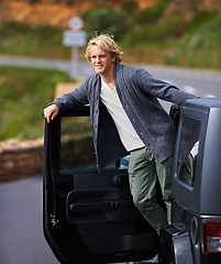 Image showing Man, car and leaning out door on road trip for travel, break or stop in nature or sightseeing. Young or handsome male person, tourist or traveler exploring or enjoying view or holiday from vehicle