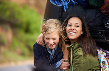 Image showing Happy woman, friends and hug with a car full of luggage for road trip, holiday weekend or outdoor vacation. Female person with smile for friendship, support or care together on adventure or journey