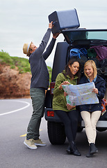 Image showing Happy woman, friends and map with a car full of luggage for road trip, destination or planning outdoor vacation. Group of young people checking travel guide and packing bags for adventure or journey