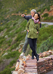 Image showing Happy couple, hiking and nature in travel for sightseeing, journey or outdoor view together. Young man and woman with smile enjoying holiday, vacation or pointing in natural environment on mountain