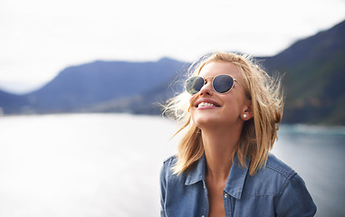 Image showing Girl, smile and peace in nature for mountain as tourist in Cape Town to relax and sun. Female person, happiness and excited for adventure on excited in trip for holiday, lake and cheerful for hiking