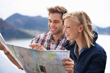 Image showing Happy people, friends and pointing to map for location, travel or destination on mountain in nature. Young couple with smile, document or paper with routes for navigation, help or outdoor tourism