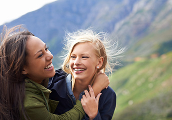Image showing Happy woman, friends and laughing with hug in nature for funny joke, humor or bonding together. Female person with smile for embrace, care or support on holiday weekend, travel or outdoor vacation