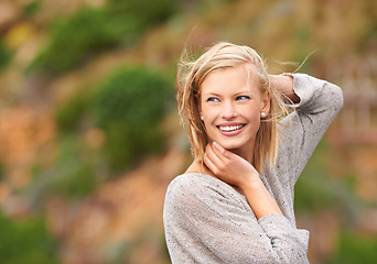Image showing Woman, nature and wind for outdoor travel on holiday vacation with smile for adventure, journey or summer. Female person, happy and breeze in California park for explore outside, paradise or freedom