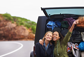 Image showing Women, friends and car trunk or road trip or excited in nature or camping holiday, vacation or explore. Female person, smile and boot with bag luggage or European adventure, transportation or journey