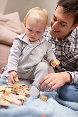 Image showing Happy father, baby and playing with blocks in home with love, pride and learning shapes or color in living room. Dad, daughter and educational toy for creativity and development of fine motor skills