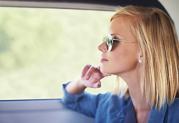 Image showing Thinking, travel and woman in a car, vacation and adventure with weekend break and sunglasses. Person, road trip and girl in a vehicle and freedom with ideas and wonder with thoughts and journey