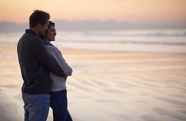 Image showing Couple, love and hug on beach at sunset with happiness together on holiday in Florida. Travel, vacation and man embrace woman outdoor on date in summer with care, support and kindness in marriage