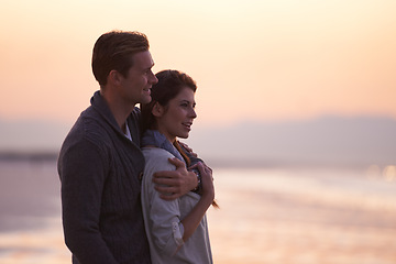 Image showing Couple, love and embrace on beach at sunset with happiness together on holiday in Florida. Travel, vacation and man hug woman outdoor on date in summer with care, support and kindness in marriage