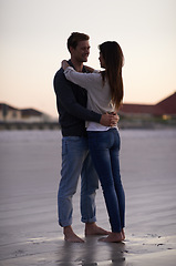 Image showing Romance, embrace and couple on beach at sunset for tropical holiday adventure, love and bonding together. Commitment, happy man and woman on romantic date with ocean, evening sky and hug on vacation.