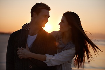 Image showing Couple hug, sunset on beach and travel for bonding, romance outdoor with love and trust. Happiness, support and loyalty with people in relationship, sunshine and adventure together with smile