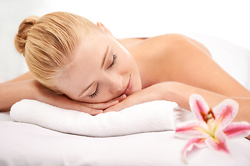 Image showing Relax, sleep and woman at spa with flower for luxury holistic treatment, facial health and professional massage therapy. Self care, peace and refresh for girl on bed in natural rest for body wellness